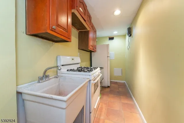 a kitchen with a sink stove and cabinets
