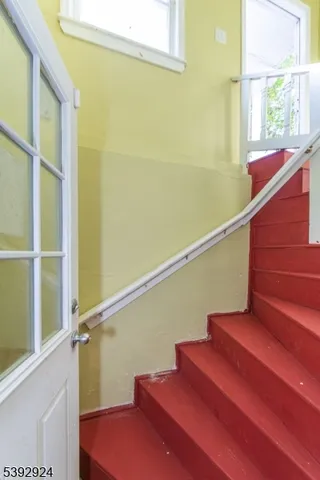 a view of entryway with wooden floor and windows