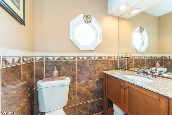 a bathroom with a granite countertop sink mirror and vanity