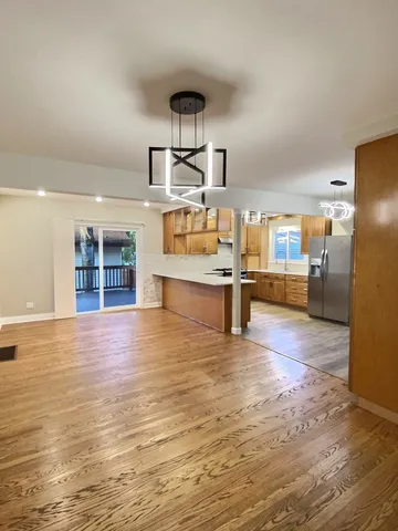 a view of a kitchen with furniture and wooden floor