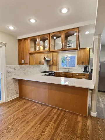 a kitchen with stainless steel appliances granite countertop a stove and a sink