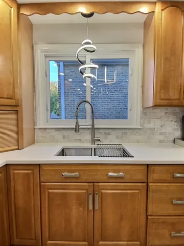 a kitchen with a sink and cabinets