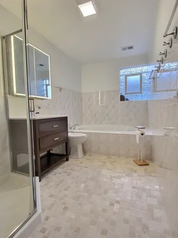 a bathroom with a bathtub and a shower