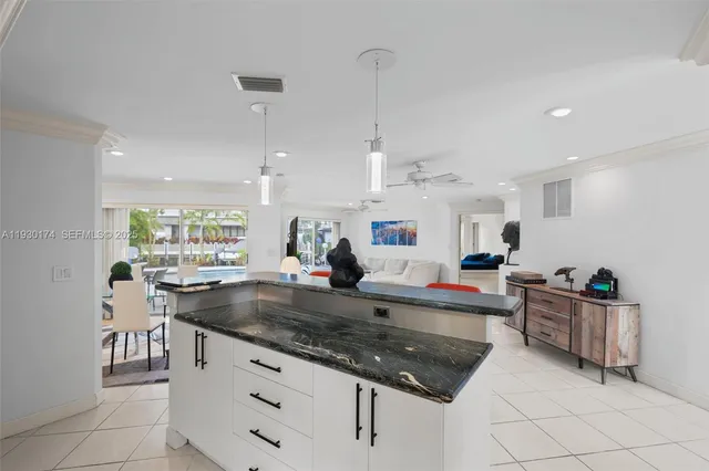 a kitchen with stainless steel appliances granite countertop a sink counter space and a window