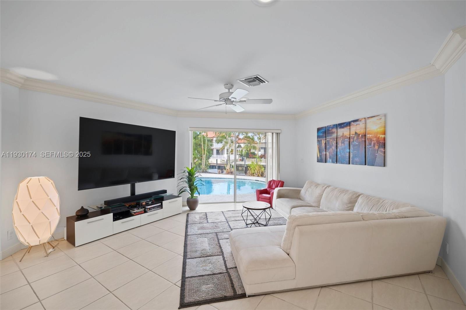 4841 Northeast 29th Avenue Lighthouse Point, FL 33064 - Photo 14 of 50 a living room with furniture and a flat screen tv