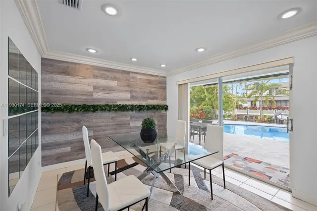 a dining room with furniture and a floor to ceiling window