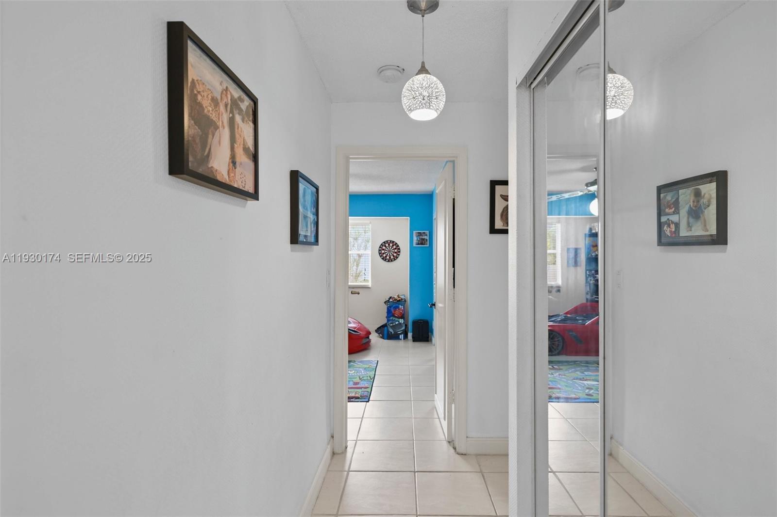 4841 Northeast 29th Avenue Lighthouse Point, FL 33064 - Photo 17 of 50 a hallway with painting on the wall and a large mirror