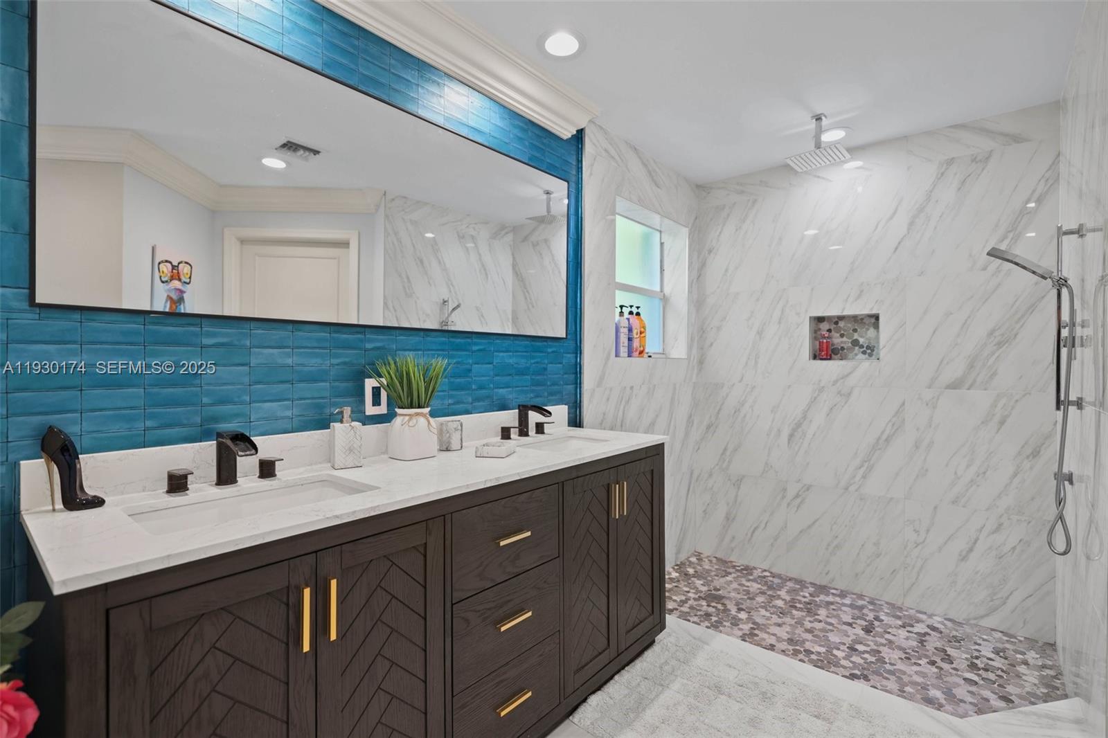 4841 Northeast 29th Avenue Lighthouse Point, FL 33064 - Photo 21 of 50 a bathroom with a sink and a mirror