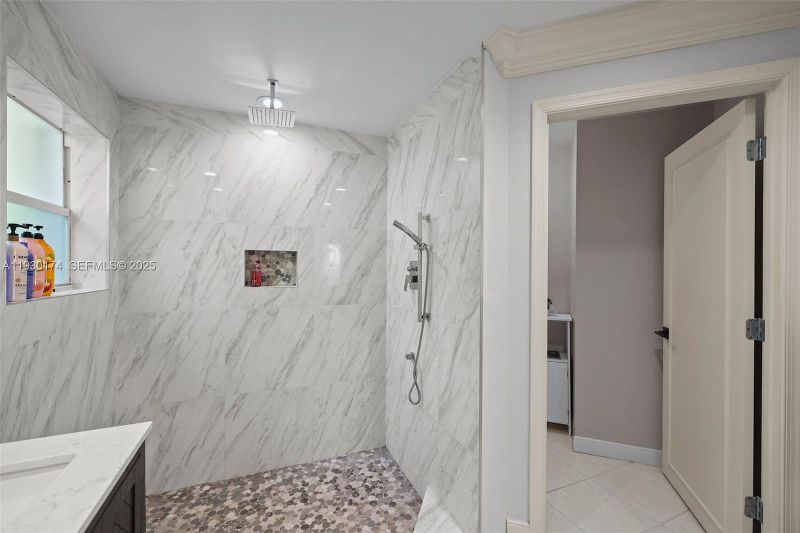 4841 Northeast 29th Avenue Lighthouse Point, FL 33064 - Photo 22 of 50 a bathroom with a shower and a sink