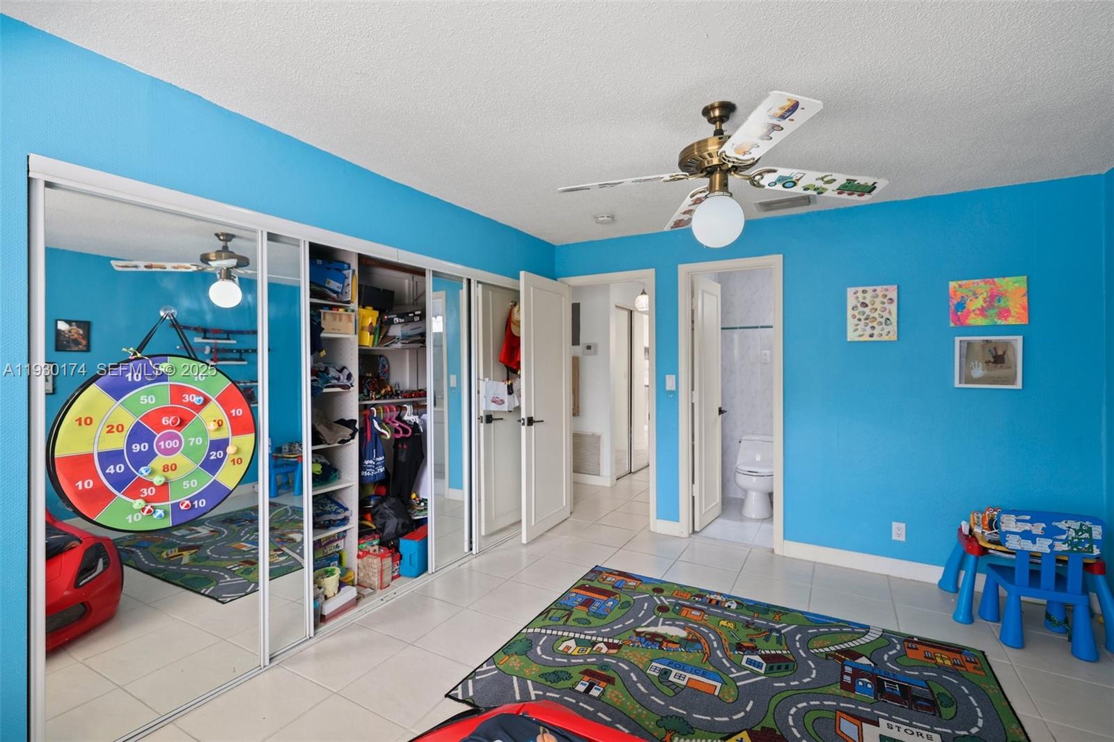 4841 Northeast 29th Avenue Lighthouse Point, FL 33064 - Photo 25 of 50 a bedroom with a bed and a chandelier