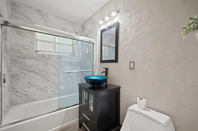 a bathroom with a toilet a sink and bathtub