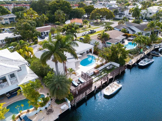 an aerial view of a house with a yard basket ball court and outdoor seating