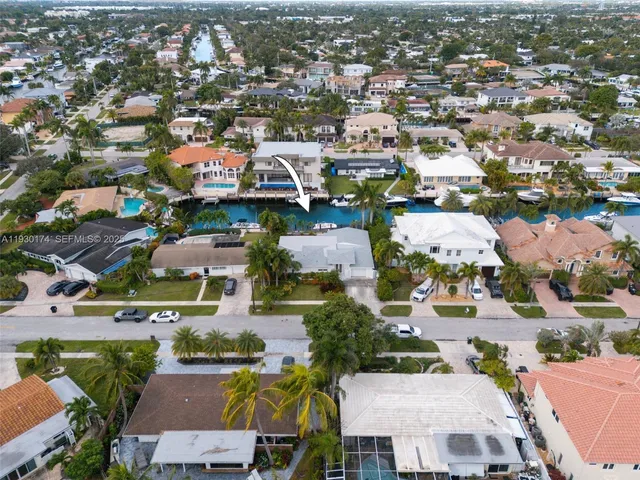 an aerial view of house with yard swimming pool and outdoor seating