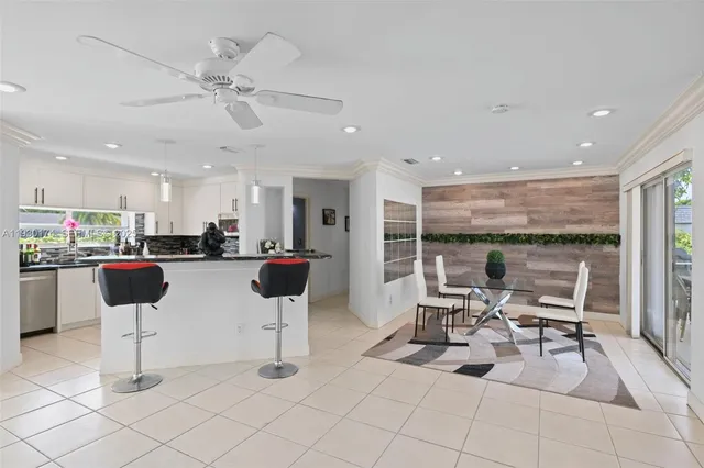 a kitchen with a dining table chairs and white glass door