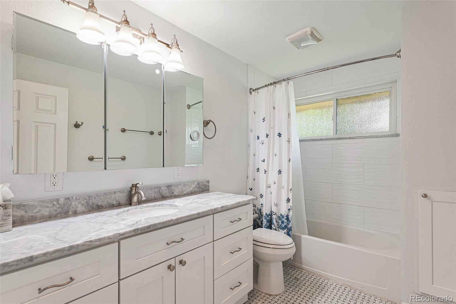 6526 South Elizabeth Way Centennial, CO 80121 - Photo 14 of 38 a bathroom with a granite countertop sink toilet and shower