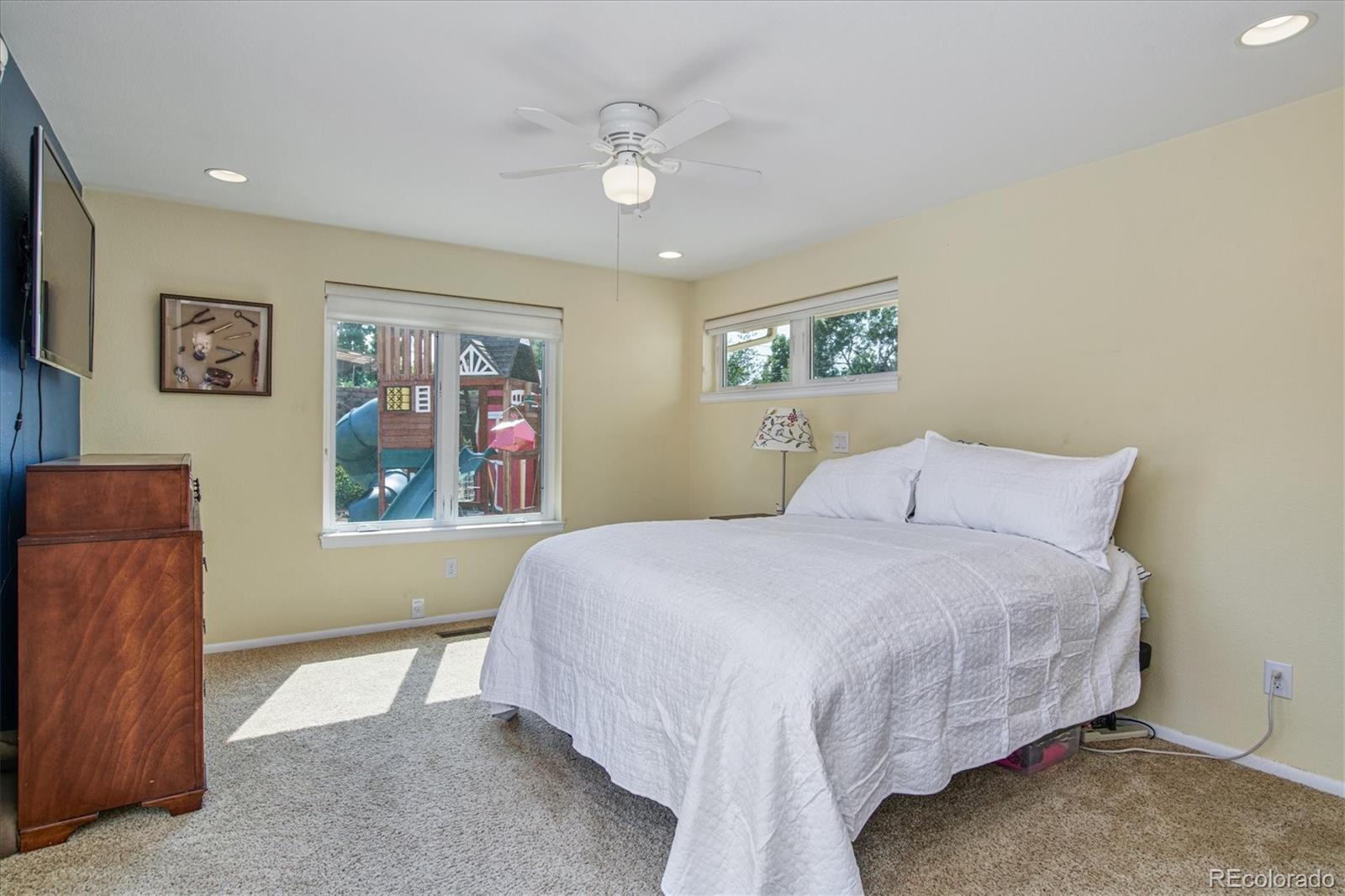 6526 South Elizabeth Way Centennial, CO 80121 - Photo 15 of 38 a bedroom with a bed and a painting on the wall