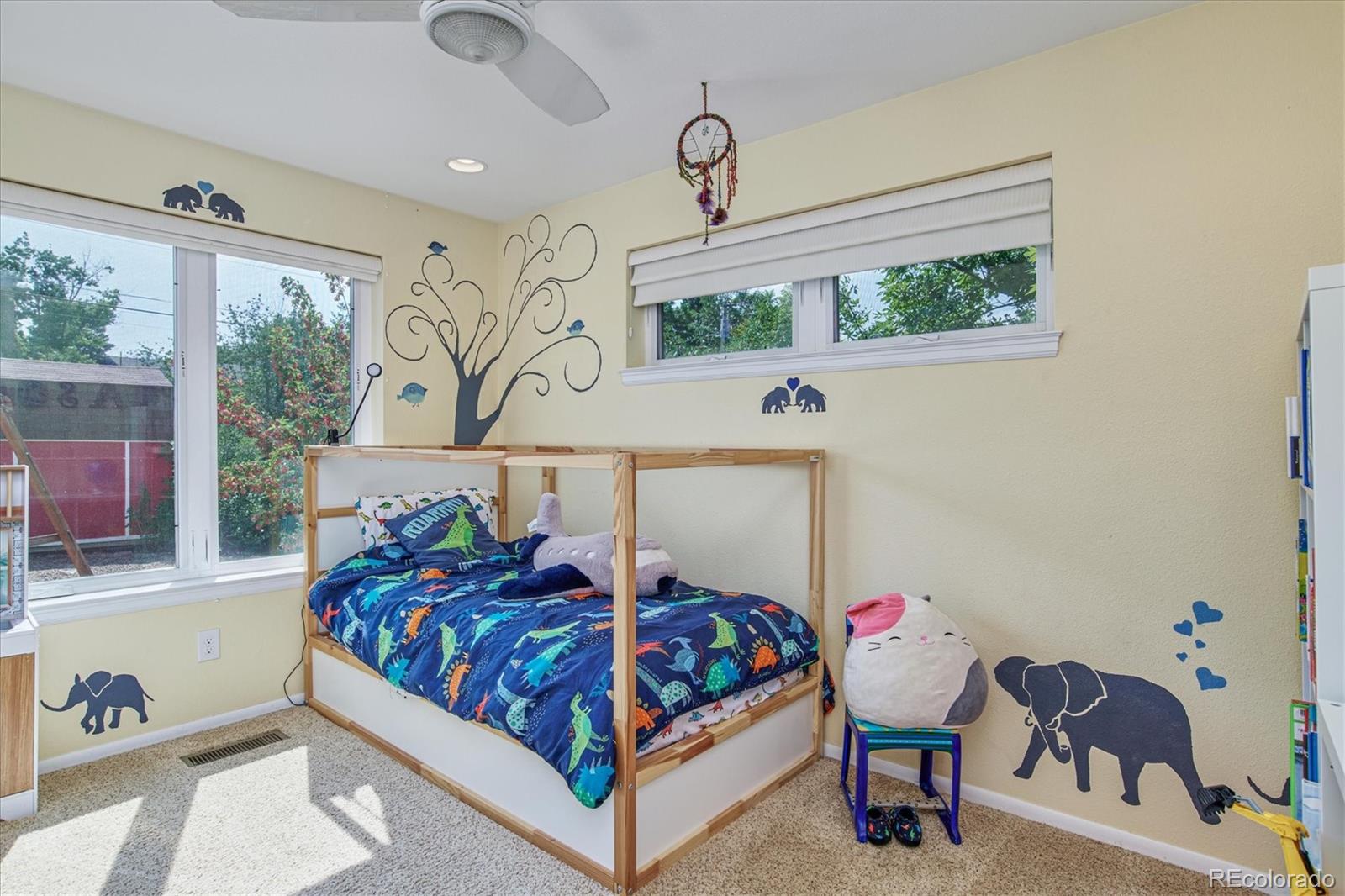 6526 South Elizabeth Way Centennial, CO 80121 - Photo 16 of 38 a bedroom with a bed a dresser and a large window