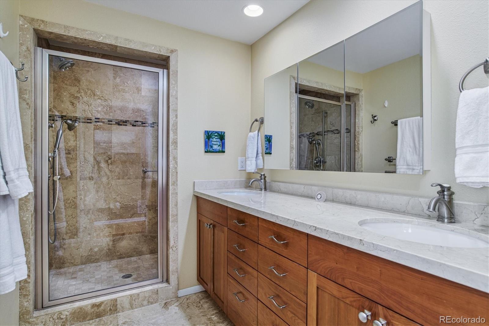 6526 South Elizabeth Way Centennial, CO 80121 - Photo 17 of 38 a bathroom with a granite countertop sink mirror and shower