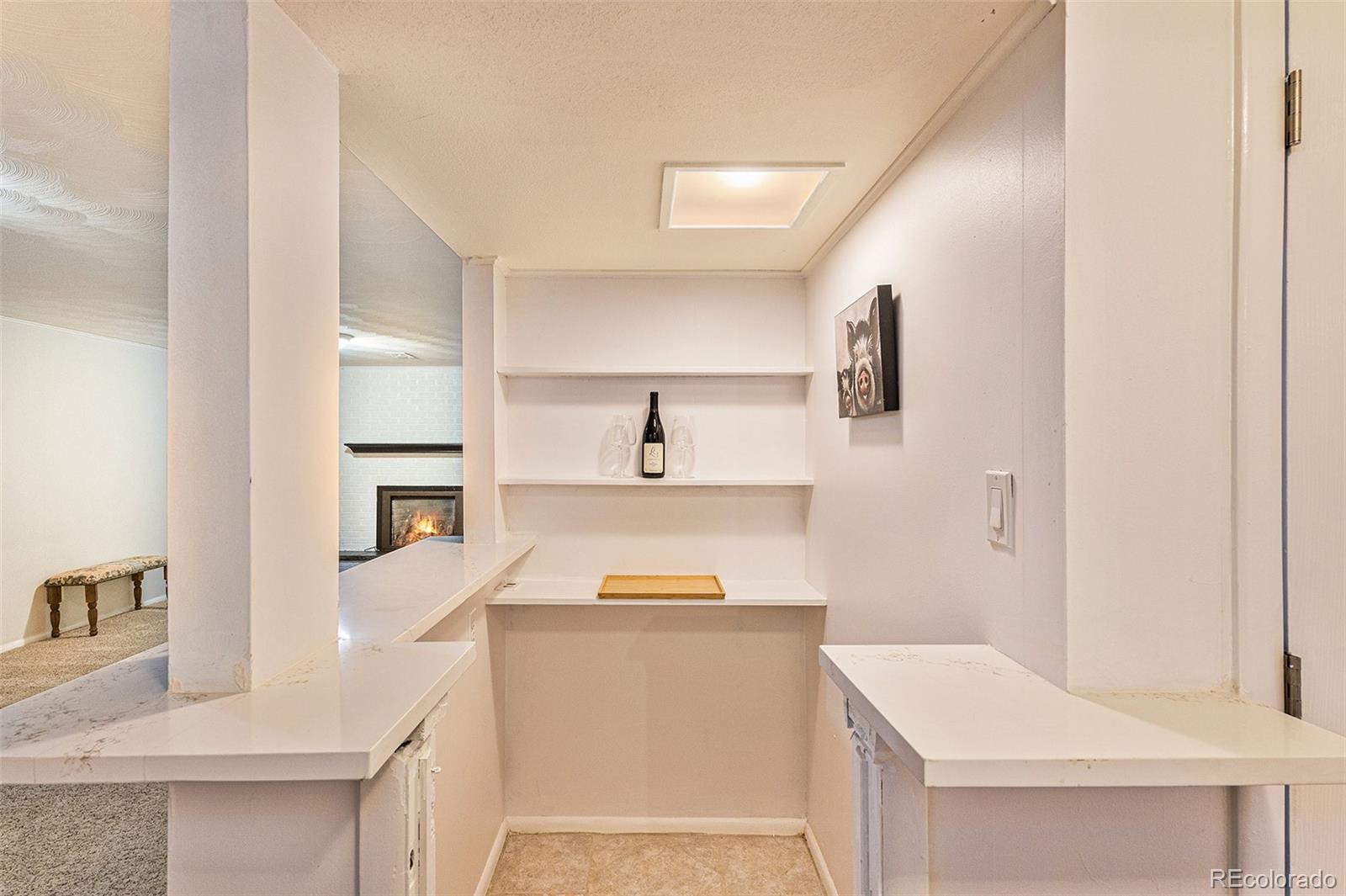 6526 South Elizabeth Way Centennial, CO 80121 - Photo 19 of 38 a kitchen with a stove and white cabinets