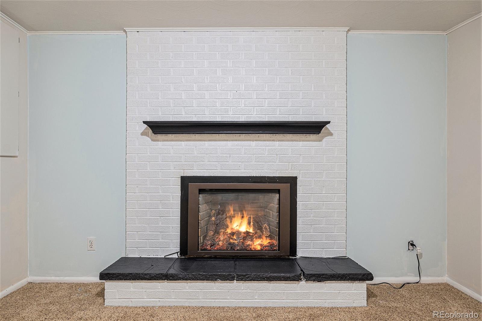 6526 South Elizabeth Way Centennial, CO 80121 - Photo 20 of 38 a living room with a fireplace