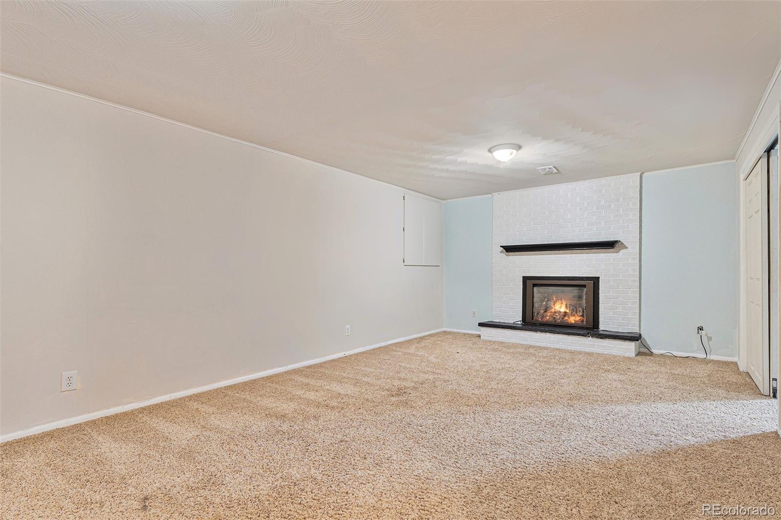 6526 South Elizabeth Way Centennial, CO 80121 - Photo 21 of 38 an empty room with a fireplace