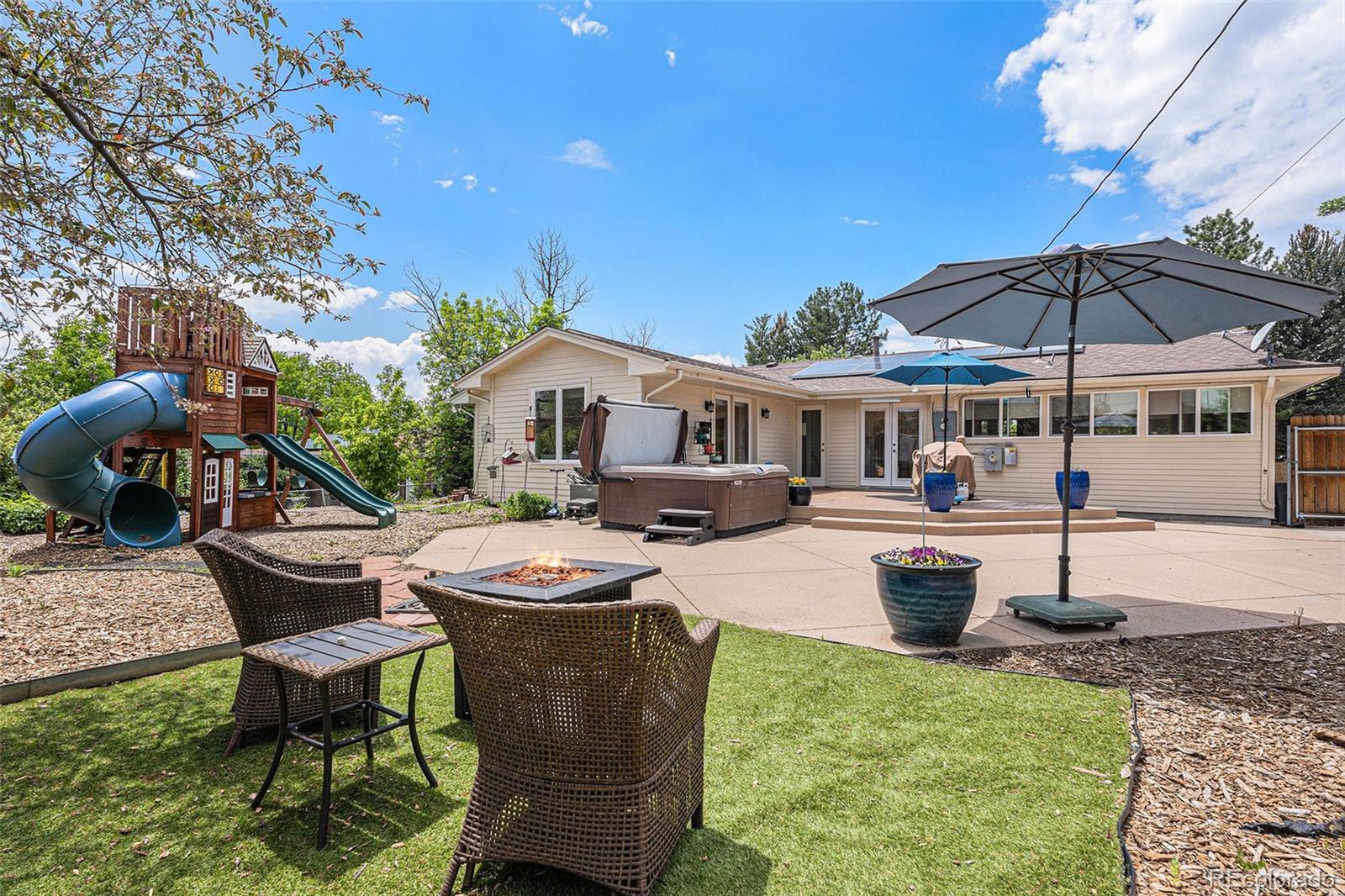6526 South Elizabeth Way Centennial, CO 80121 - Photo 27 of 38 a view of a house with backyard sitting area and furniture