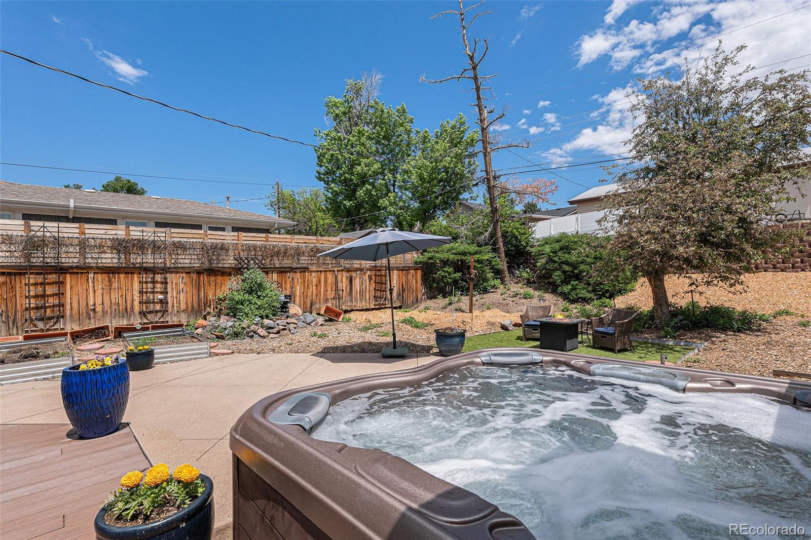 6526 South Elizabeth Way Centennial, CO 80121 - Photo 29 of 38 a view of a patio with table and chairs under an umbrella