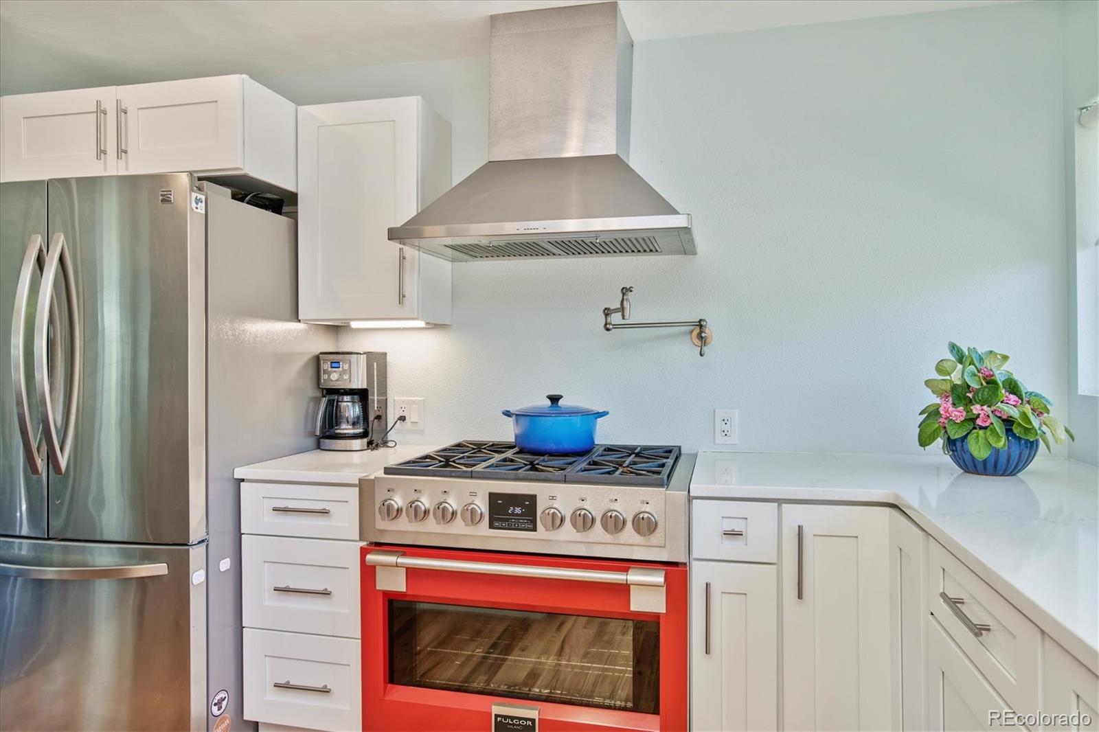 6526 South Elizabeth Way Centennial, CO 80121 - Photo 6 of 38 a kitchen with stainless steel appliances a stove a refrigerator and cabinets