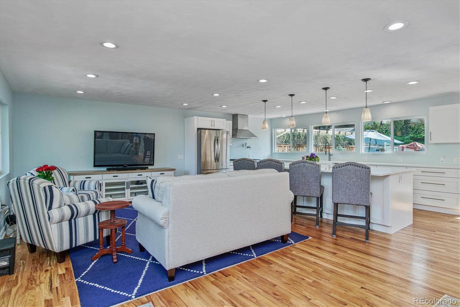 6526 South Elizabeth Way Centennial, CO 80121 - Photo 10 of 38 a living room with furniture a flat screen tv and a table