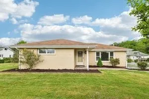 a front view of house with yard and green space