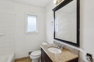 200 Edgewood Street Aliquippa, PA 15001 - Photo 18 of 47 a bathroom with a granite countertop sink toilet and a mirror
