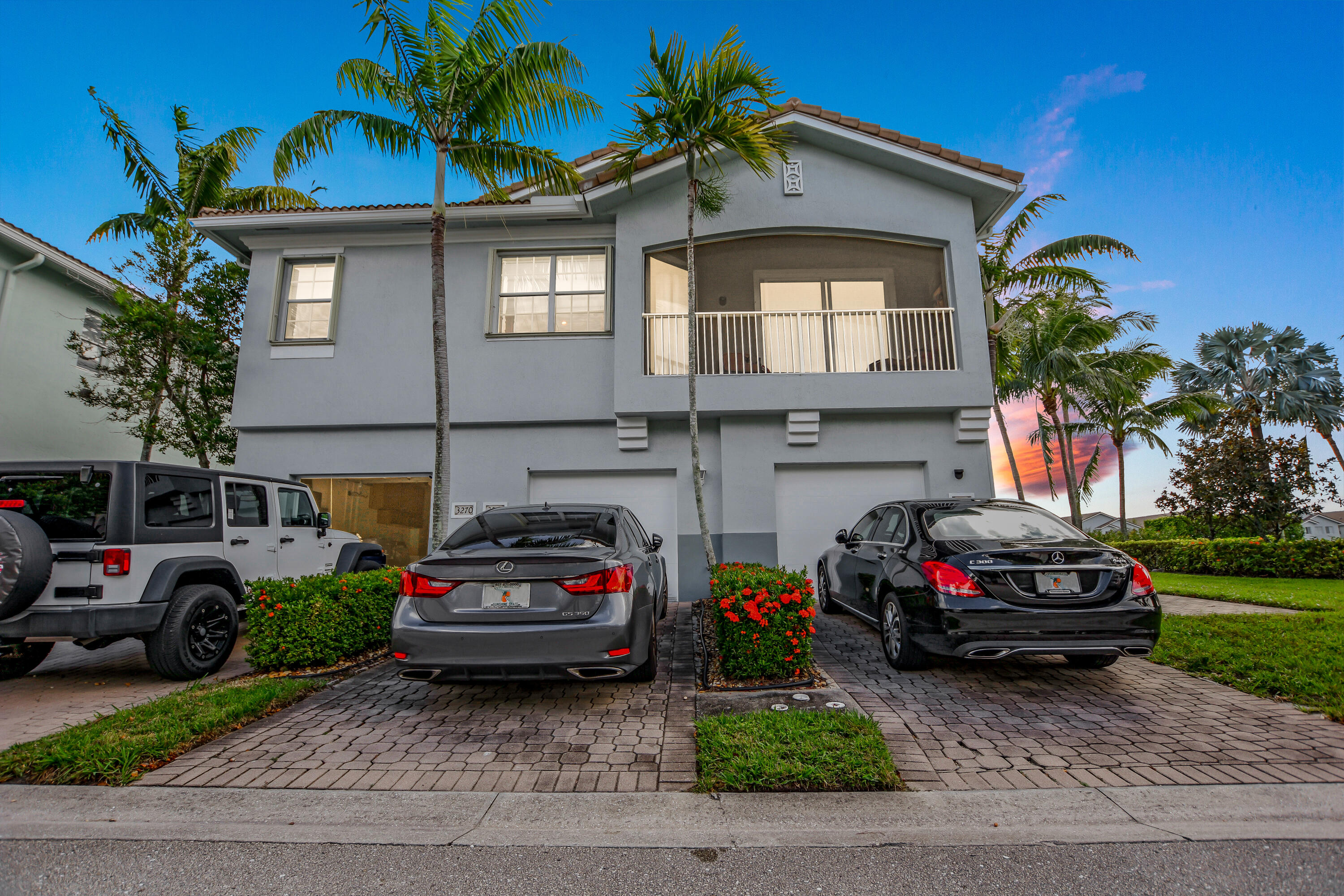 3268 Laurel Ridge Circle Riviera Beach, FL 33404 - Photo 20 of 33 Garage Driveway Twilight