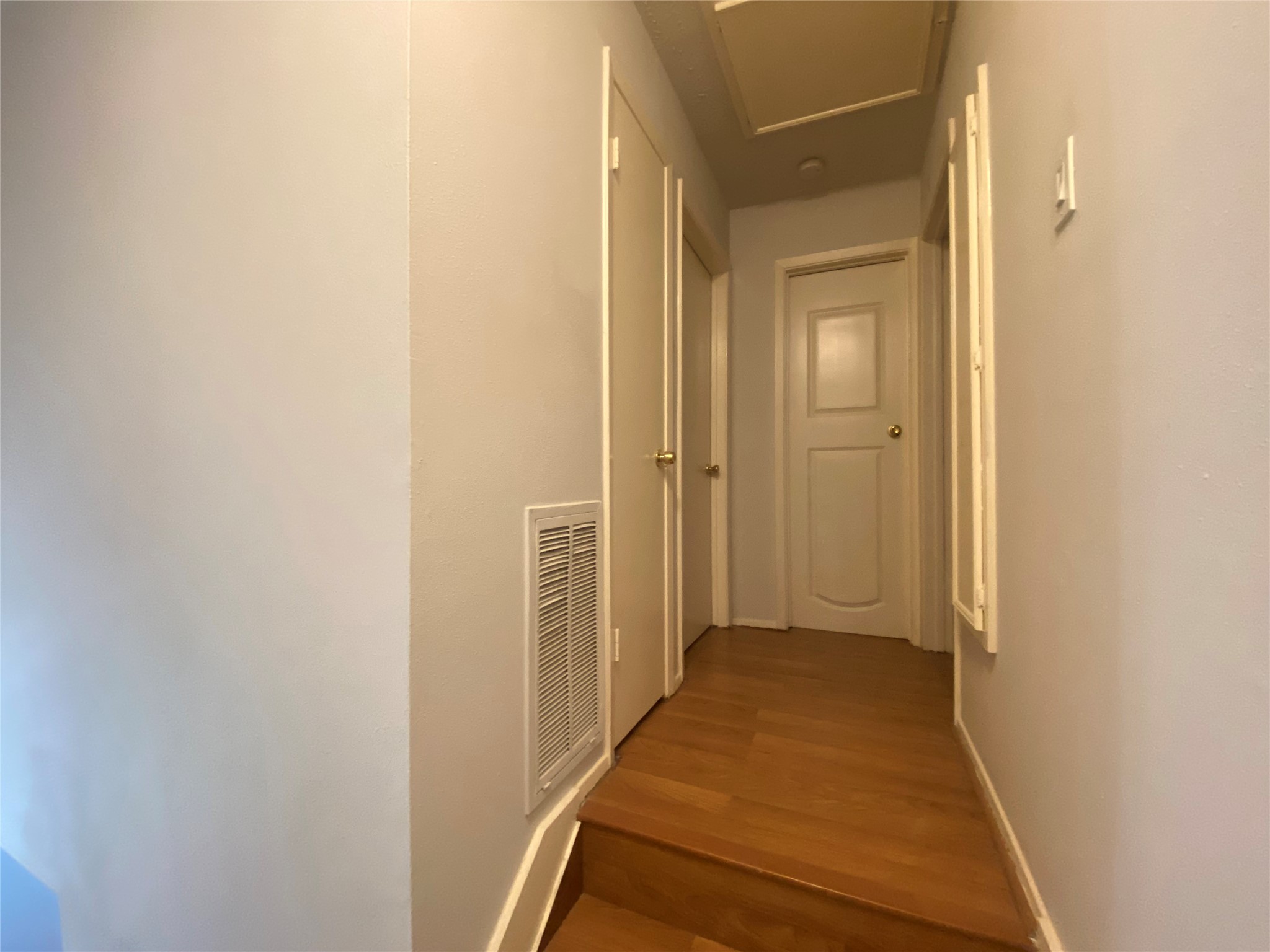 12177 Sharpview Drive Houston, TX 77072 - Photo 14 of 30 a view of a hallway with wooden floor