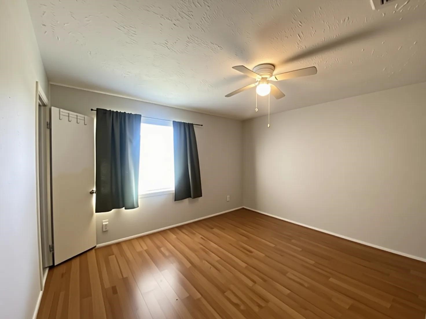 12177 Sharpview Drive Houston, TX 77072 - Photo 16 of 30 a view of an empty room with window and wooden floor