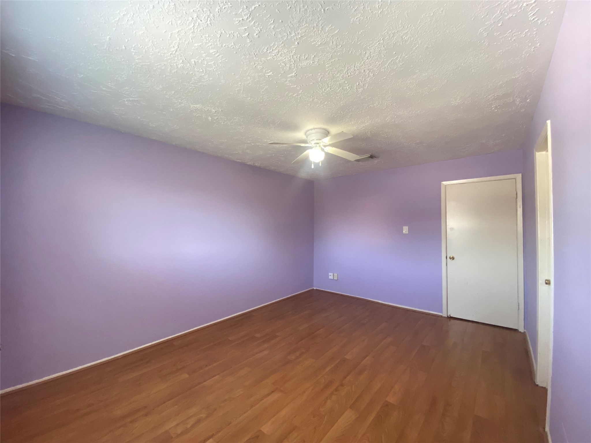 12177 Sharpview Drive Houston, TX 77072 - Photo 18 of 30 an empty room with a chandelier fan and windows