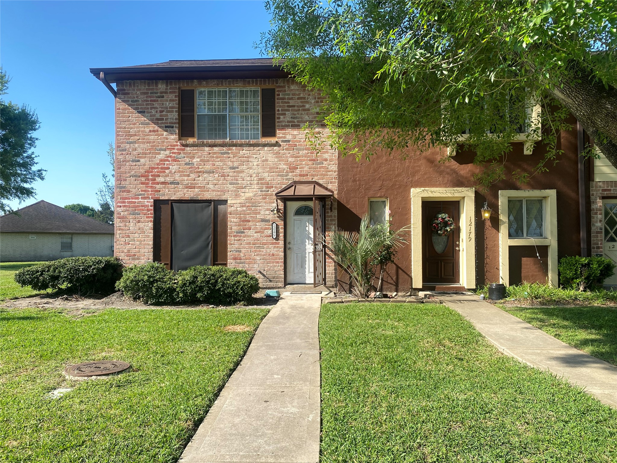 12177 Sharpview Drive Houston, TX 77072 - Photo 3 of 30 a front view of a house with a yard and garage