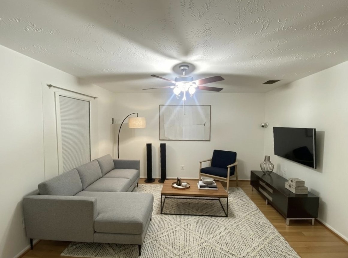 12177 Sharpview Drive Houston, TX 77072 - Photo 7 of 30 a living room with furniture a flat screen tv and a chandelier