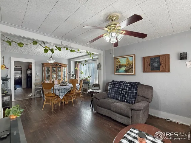 a living room with furniture wooden floor and a chandelier