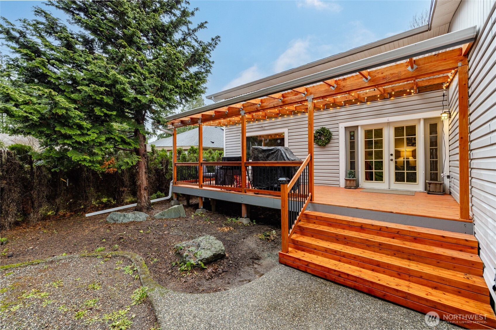 9543 Columbia Way Sedro-Woolley, WA 98284 - Photo 2 of 38 a backyard of a house with barbeque oven and outdoor seating