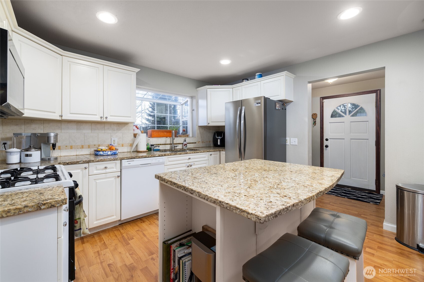 9543 Columbia Way Sedro-Woolley, WA 98284 - Photo 21 of 38 a kitchen with granite countertop kitchen island stainless steel appliances a refrigerator sink and stove