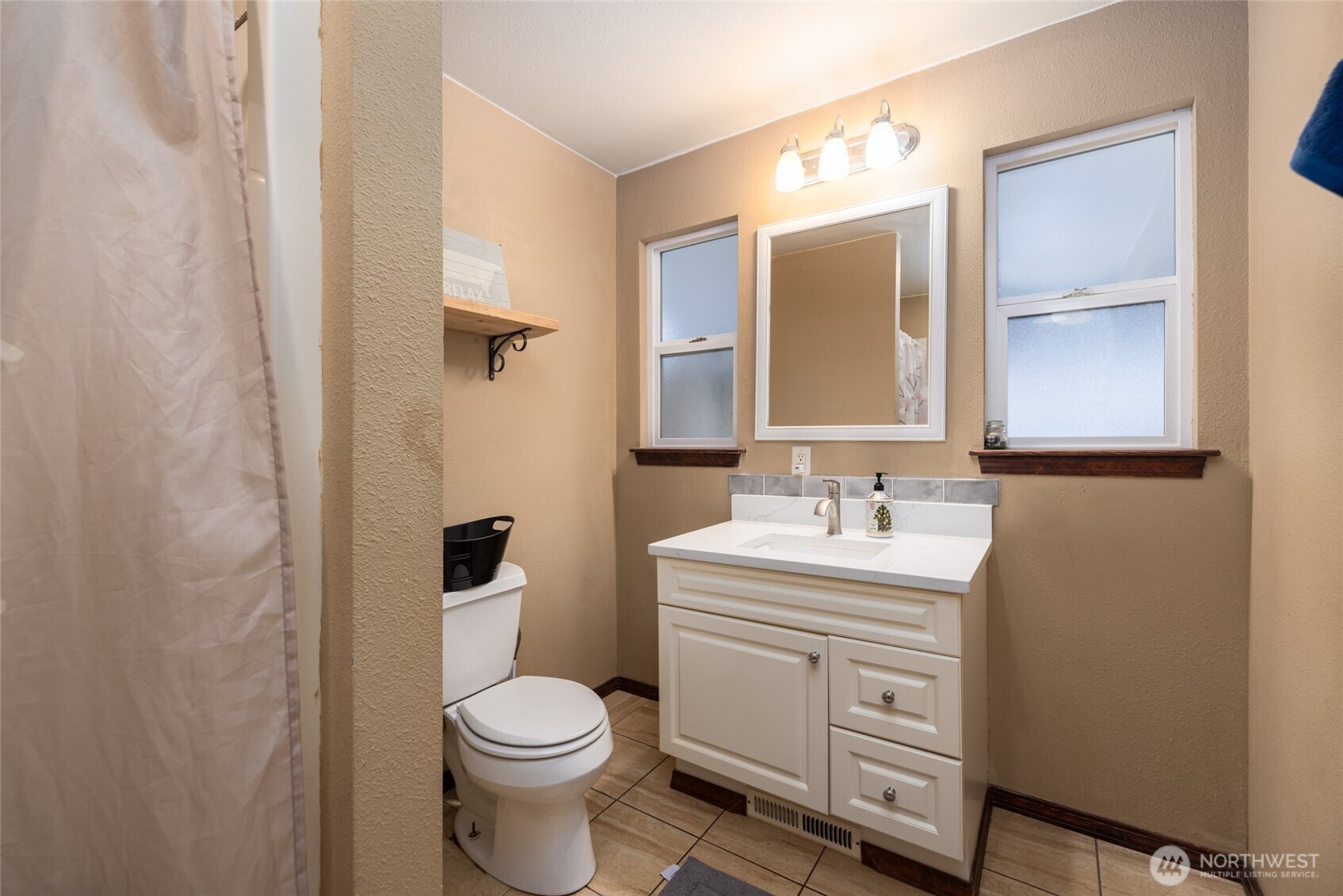 9543 Columbia Way Sedro-Woolley, WA 98284 - Photo 32 of 38 a bathroom with a sink a toilet and mirror