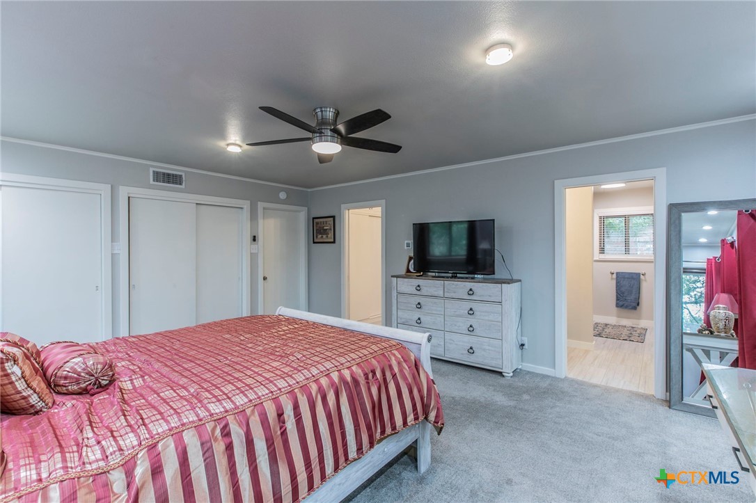 2518 Marlandwood Road Temple, TX 76502 - Photo 19 of 48 a spacious bedroom with a bed and a flat screen tv