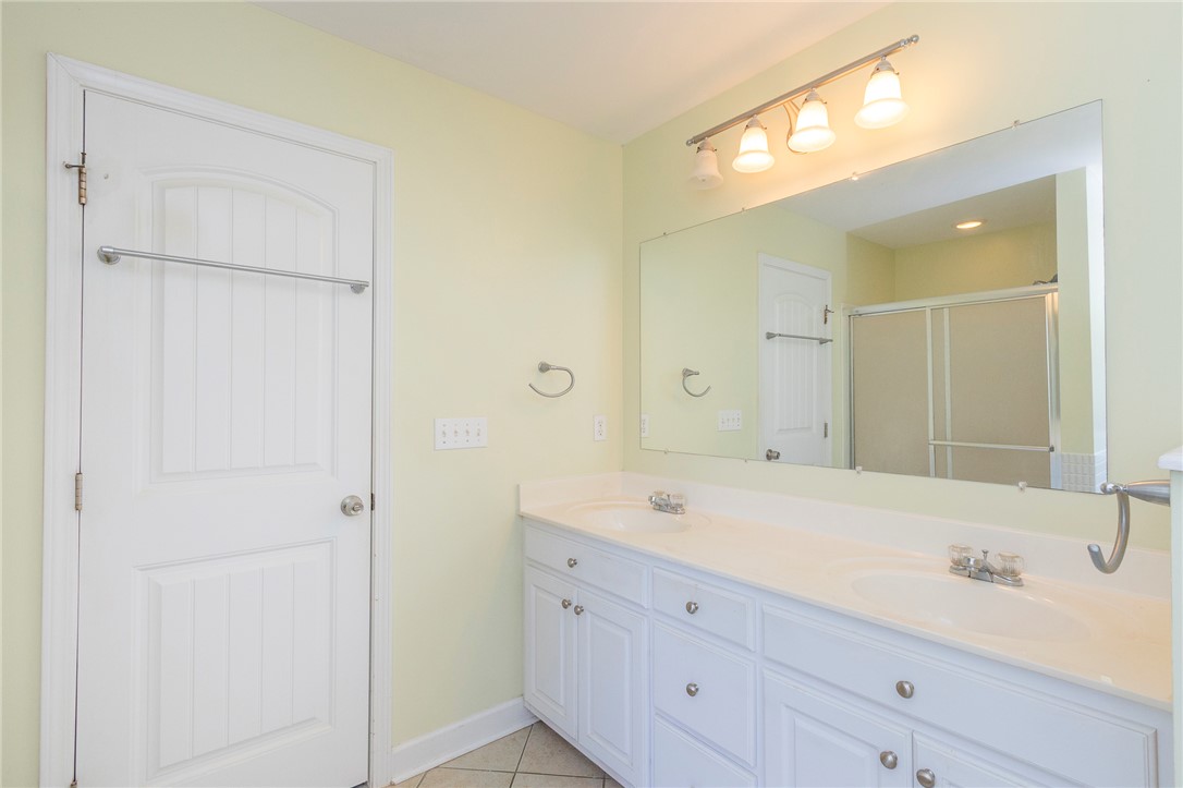 861 North Old Pendleton Road Liberty, SC 29657 - Photo 26 of 45 Double vanity sinks and bright track lighting illuminate this pristine bathroom space.