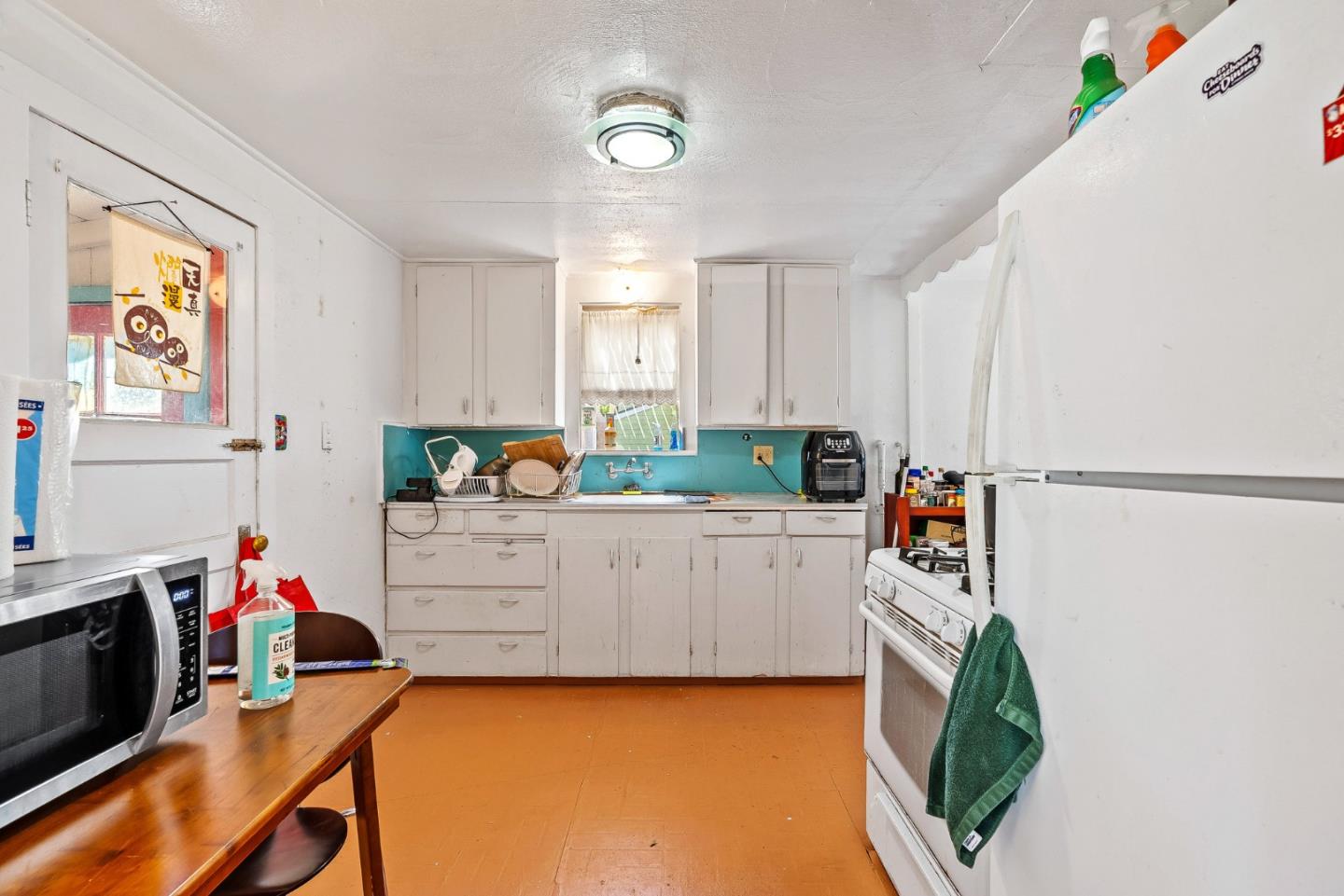 1430 Merrill Street Santa Cruz, CA 95062 - Photo 17 of 40 a kitchen with stainless steel appliances a stove a sink cabinets and a window