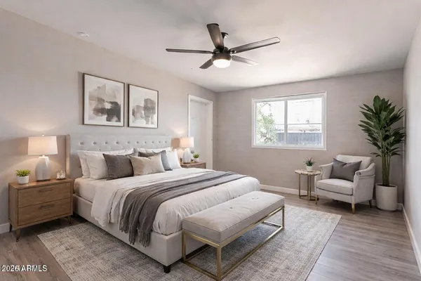 a bedroom with a bed a couch and a window