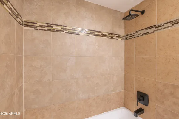 a bathroom with a shower and a shower head