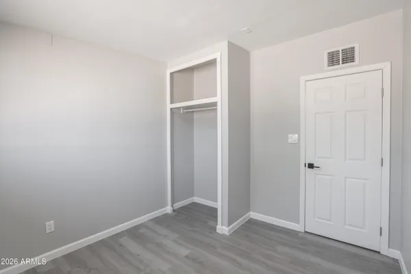 an empty room with wooden floor