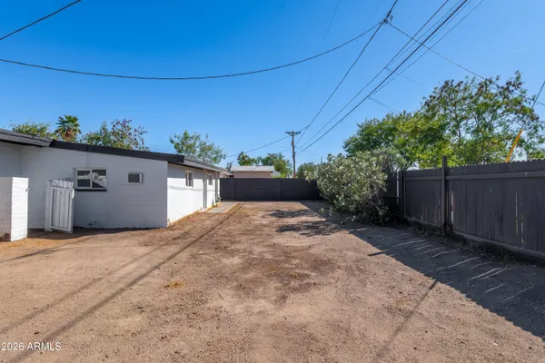 a view of a house with a backyard and a garage