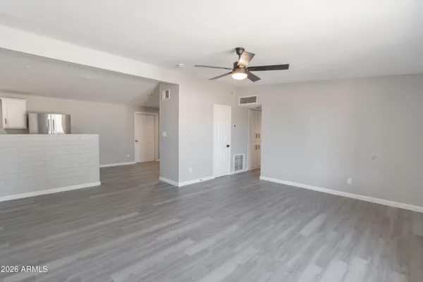 a view of an empty room with wooden floor