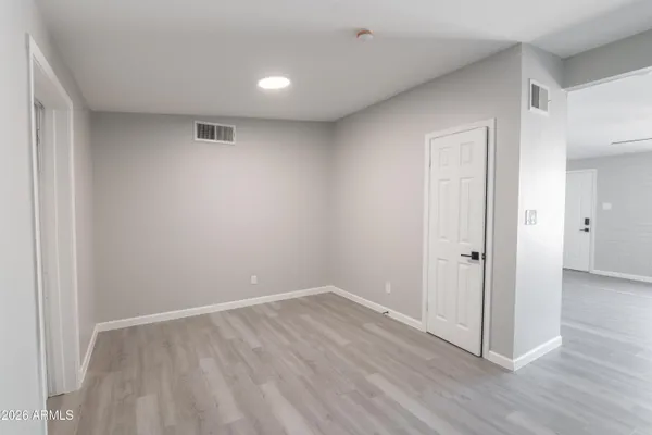 a view of an empty room with wooden floor